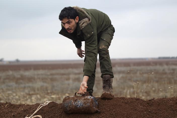 In Syria, a rebel fighter clears Islamic State minefields